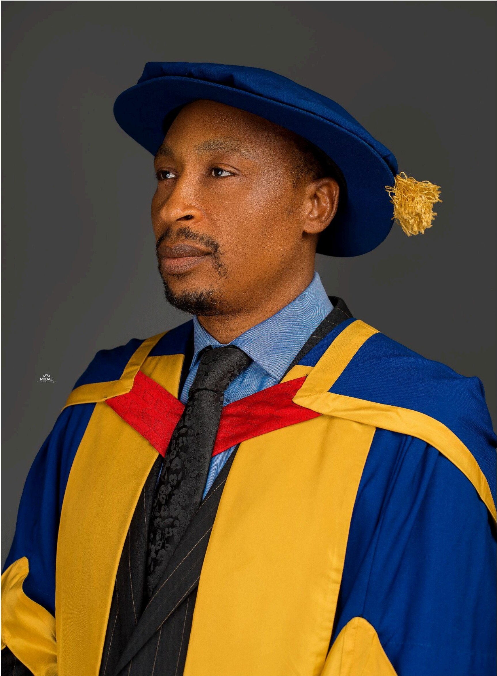 Portrait of Professor Ike-Elechi Ogba in academic regalia